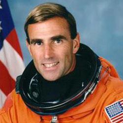 A man in an orange suit and helmet.